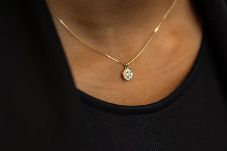 close up of a woman's neck wearing glacier fire diamond pendant