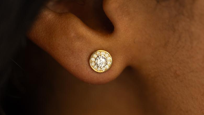 close up of a woman's ear wearing glacier fire diamond earrings