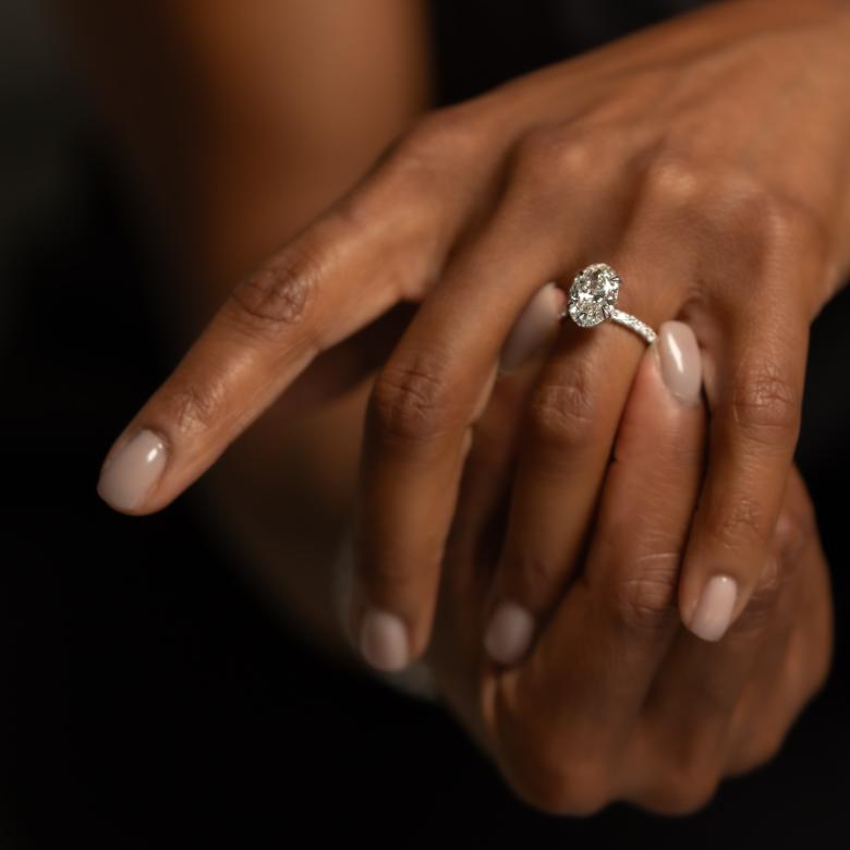 Close up of woman's hand wearing New Brilliance Diamond Ring