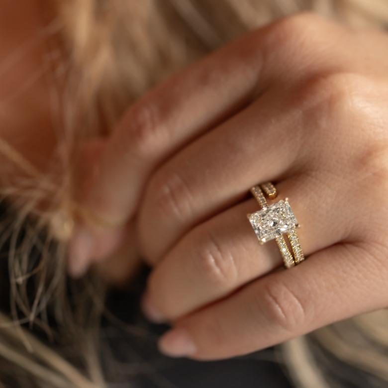 Close up of woman's hand wearing New Brilliance Diamond Ring